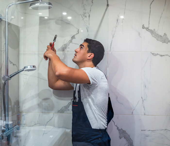 person installing shower head